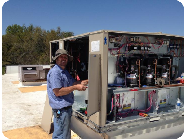 Technician repairing commercial HVAC unit